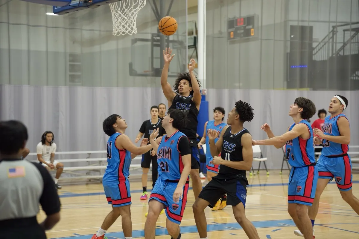 Player leaping to shoot during competitive basketball game
