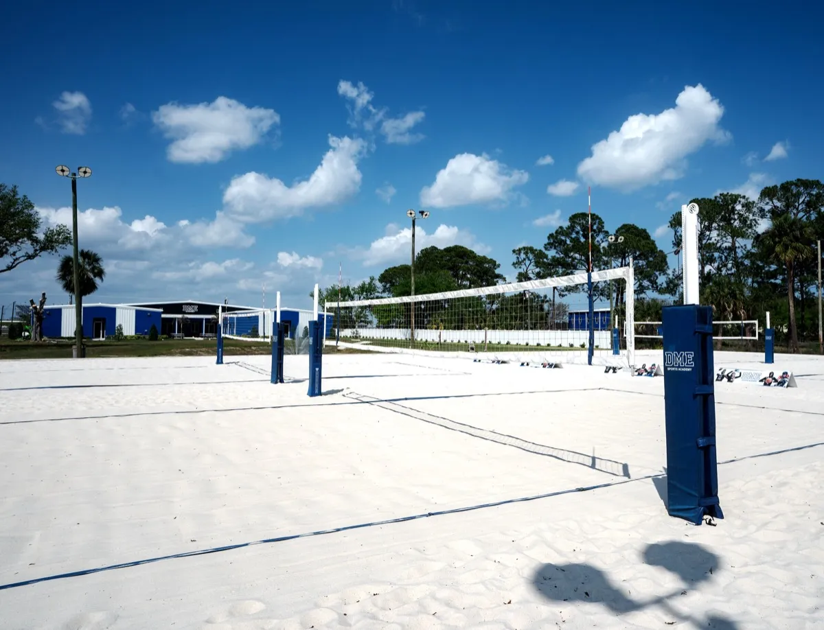 Beach volleyball courts with DME Academy building